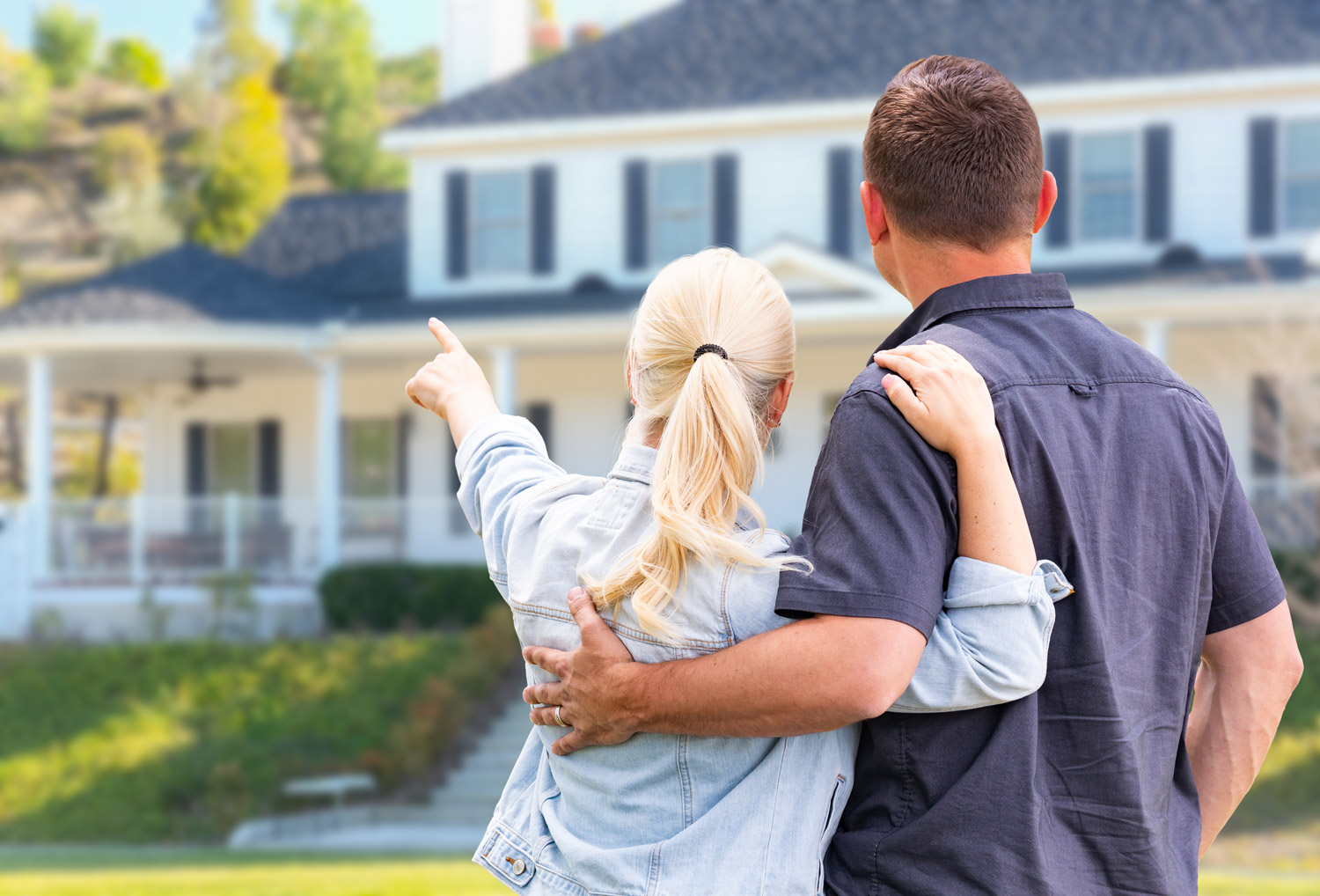 man and woman looking at a house